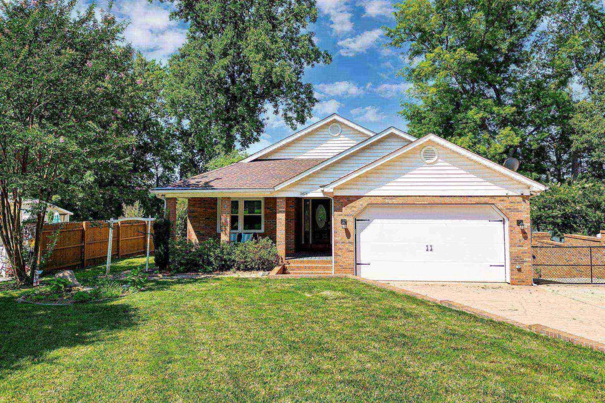 A charming exterior view of the home, featuring a welcoming front porch surrounded by a well-maintained lawn and large windows. The brick facade invites a sense of small-town warmth and hospitality, perfect for guests arriving from a day out in Belmont.